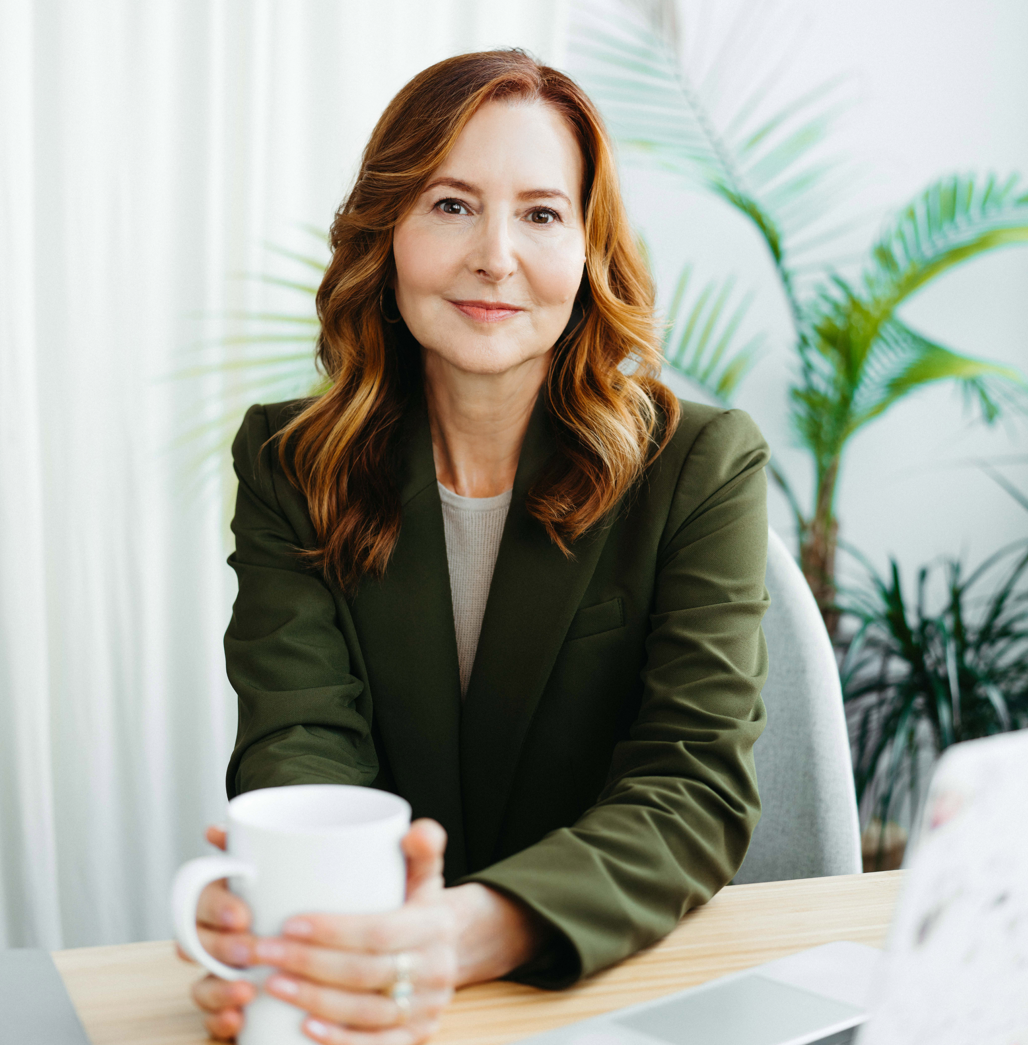 Dr. Erica Mindes seated at her desk, smiling